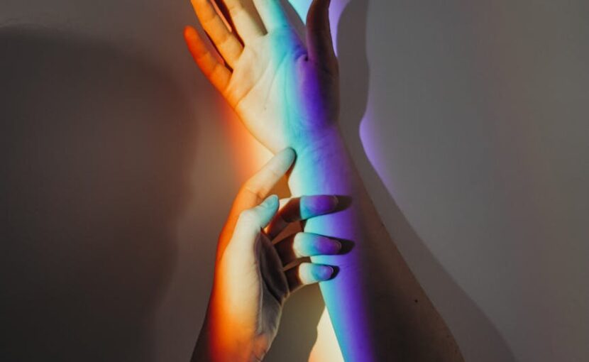 persons hands with rainbow colors
