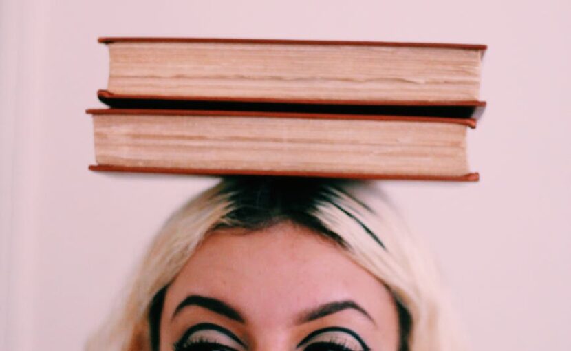 two book on woman head