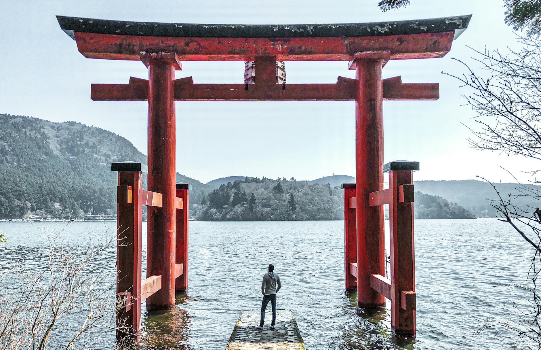 man in gray jacket standing on dock