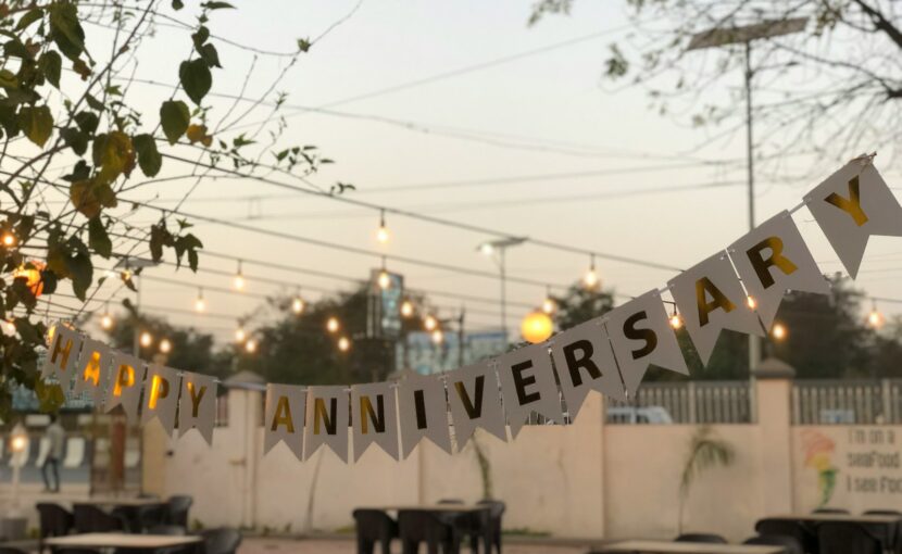 a party banner hanging over a table in a restaurant