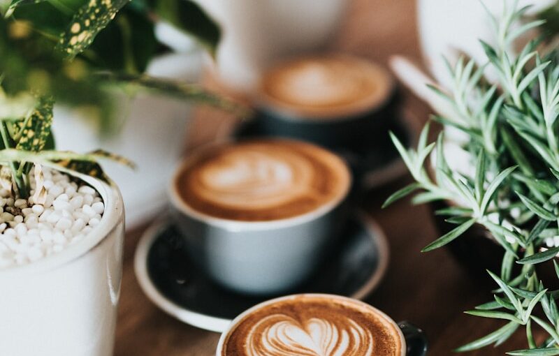 shallow focus photography of coffee late in mug on table